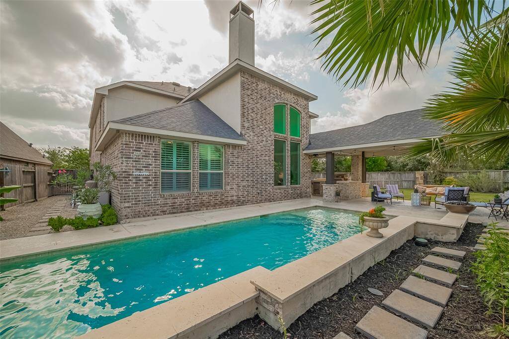 The neatly graveled side yard ensures no muddy areas and offers convenient access to the pool equipment