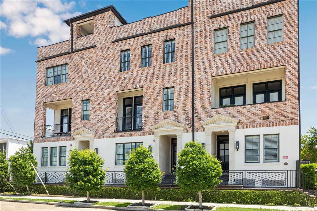 Immaculately maintained brick and stucco exterior with covered and gated front entry.