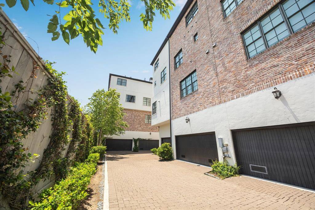 Rear garage entrance off the controlled-access gated driveway is safe and private, with a whisper-quiet double garage door.