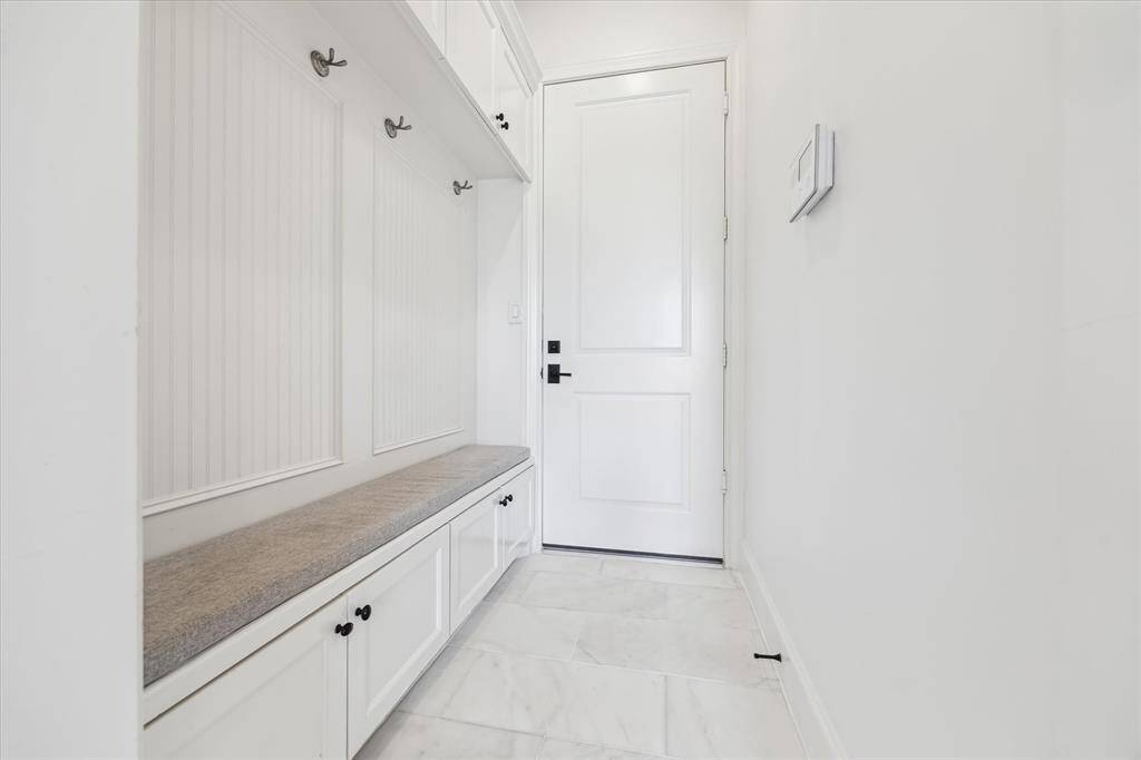 Convenient mudroom and dropzone area directly off the garage opens into the foyer. Plenty of closed storage for ease and accessibility.