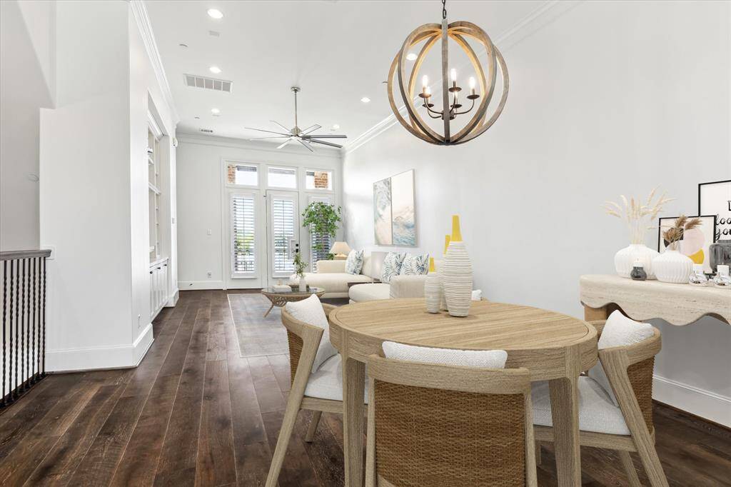 Upstairs on the 2nd floor is the main living and dining area. Gorgeous hardwood flooring, Built-in custom entertainment cabinetry, 12 ft ceilings with crown molding. Sweet, private terrace at the far end.