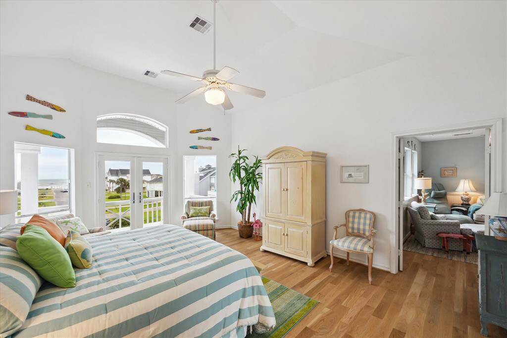 Secondary bedroom on West side - Main Floor - with balcony deck with views.  High ceilings, fans and carpet make the room so airy and comfortable.