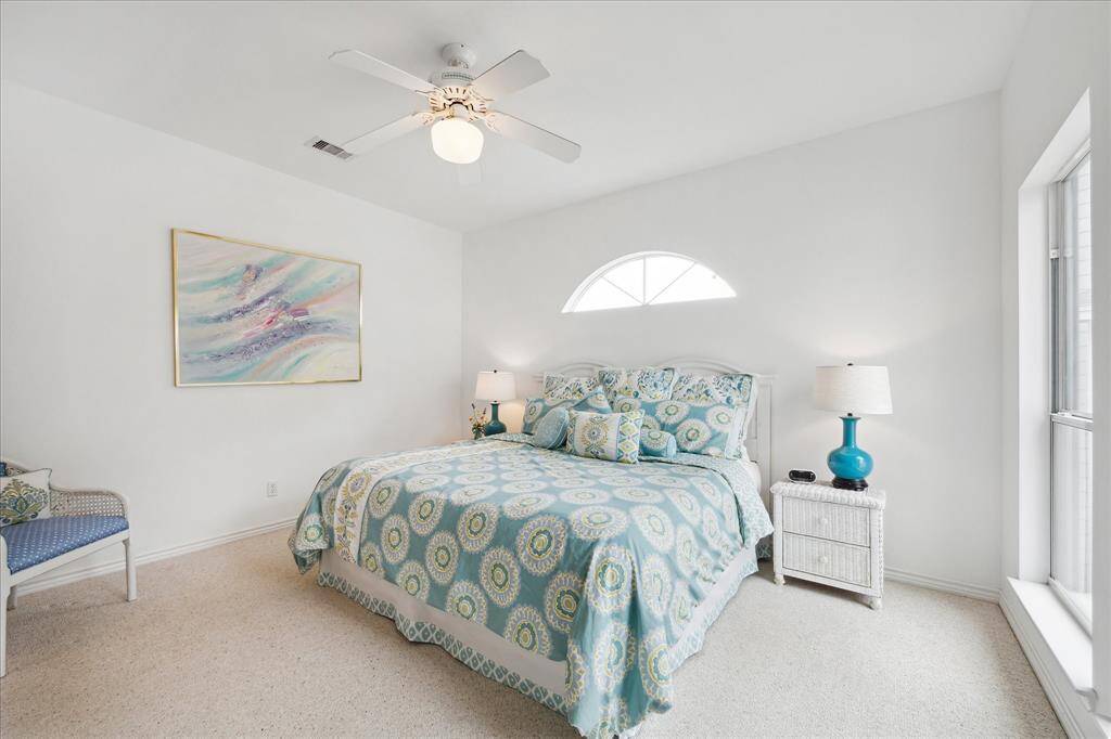 Ample sized light filled - co-primary Private Bedroom & Ensuite - East Wing - 2nd flr living - what an oasis!  Double doors lead out to the balcony deck with beautiful views! Wood Flooring , ceiling fans.