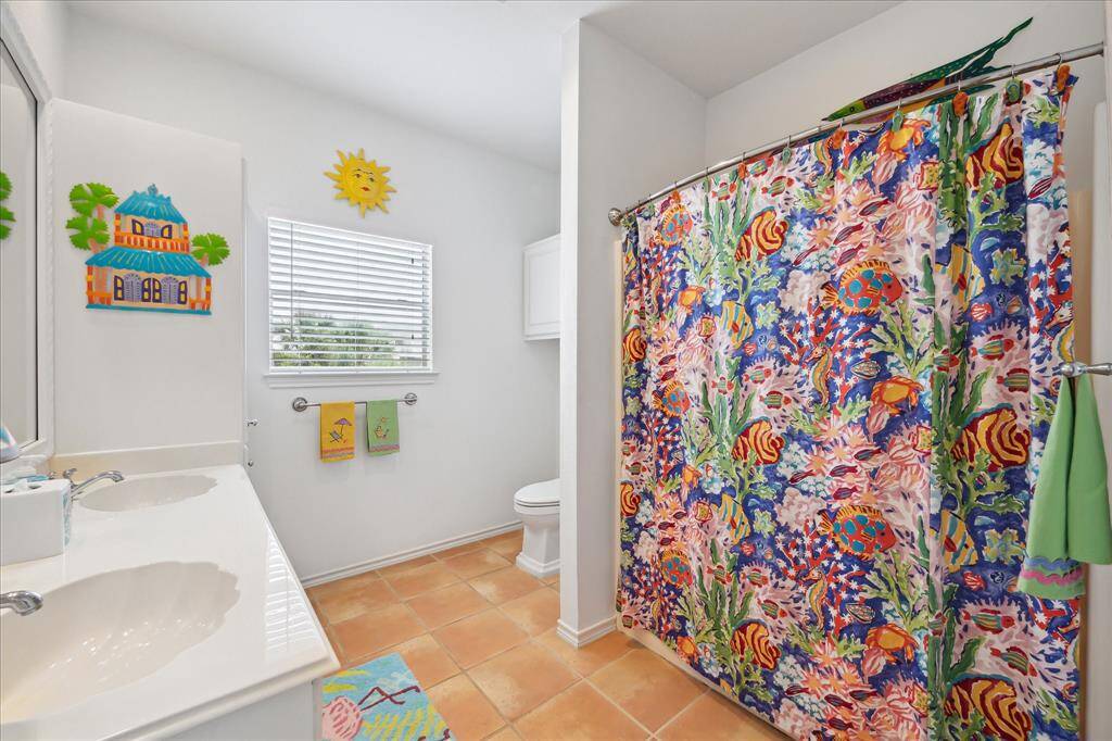 Another view of the co-primary private bedroom with double door entrance and doors leading to the ensuite bathroom.