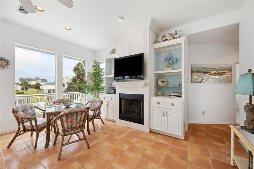 View of the Great Room| Dining room, showing the built in television over the Fireplace with gas logs| Propane. Built-in cabintry with plenty of display and storage options.  Breakfast area has great views for your am coffee.
