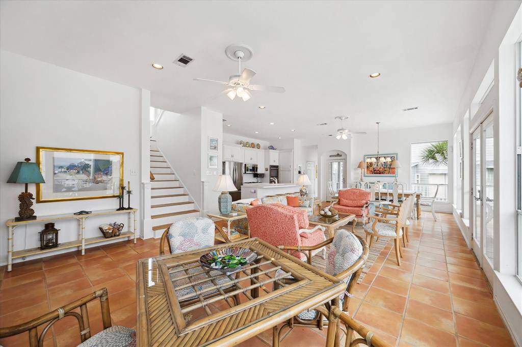 Another view of the Great room showcasing the open concept with kitchen and dining area all at easy access. Dining area with full size dining table. Patio doors lead out to the balcony deck.
