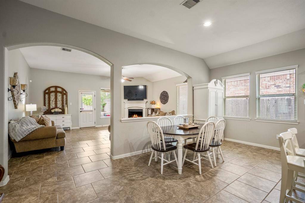 The dining area offers a bright, welcoming space for meals, with views into the living room through graceful archways that provide an open feel while still defining each space.