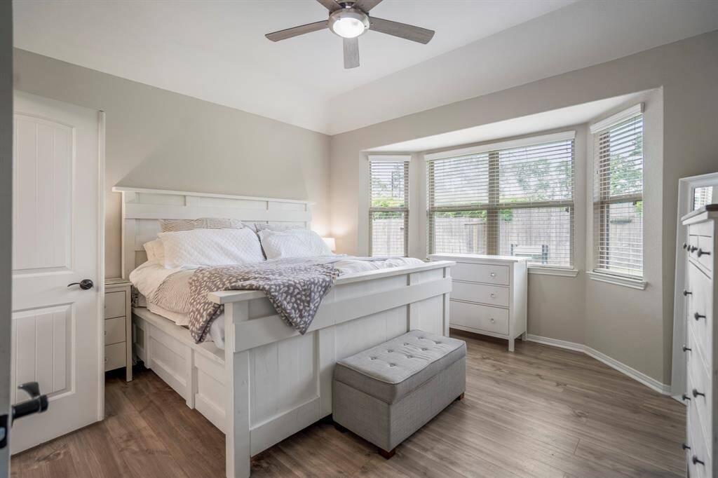 Step into your peaceful primary bedroom retreat, tucked quietly at the back of the home. Bright bay windows frame serene views of the backyard, while easy-to-maintain vinyl plank floors add a touch of warmth and comfort underfoot. A perfect spot to unwind and recharge.