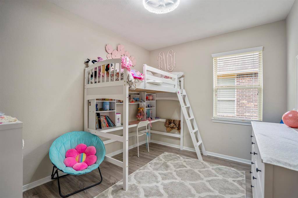 The fourth bedroom boasts vinyl plank floors and a lovely window that lets in plenty of natural light, creating a bright and inviting space.