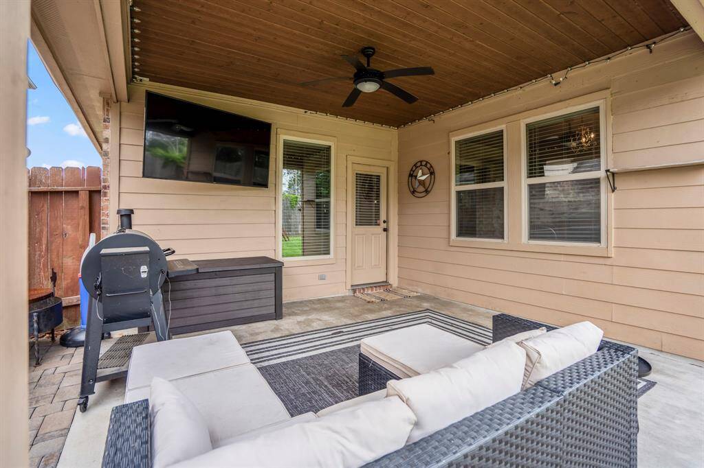 Looking back toward the back door, you get a cozy view of the covered patio’s warm wood ceiling and spacious layout—an ideal spot to enjoy morning coffee or unwind after a long day.