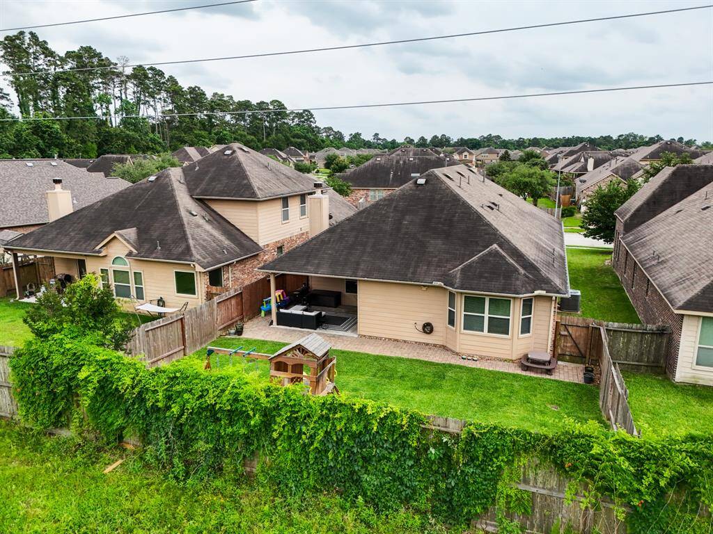 This aerial view just above fence height showcases the generous backyard space and the peaceful privacy of no rear neighbors—your own serene outdoor retreat right at home.