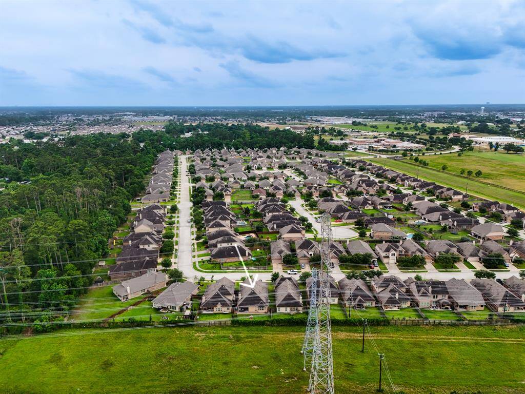 From a vantage point over the greenbelt, this view highlights the home’s serene setting surrounded by nature, showing how seamlessly it blends into the peaceful community landscape.
