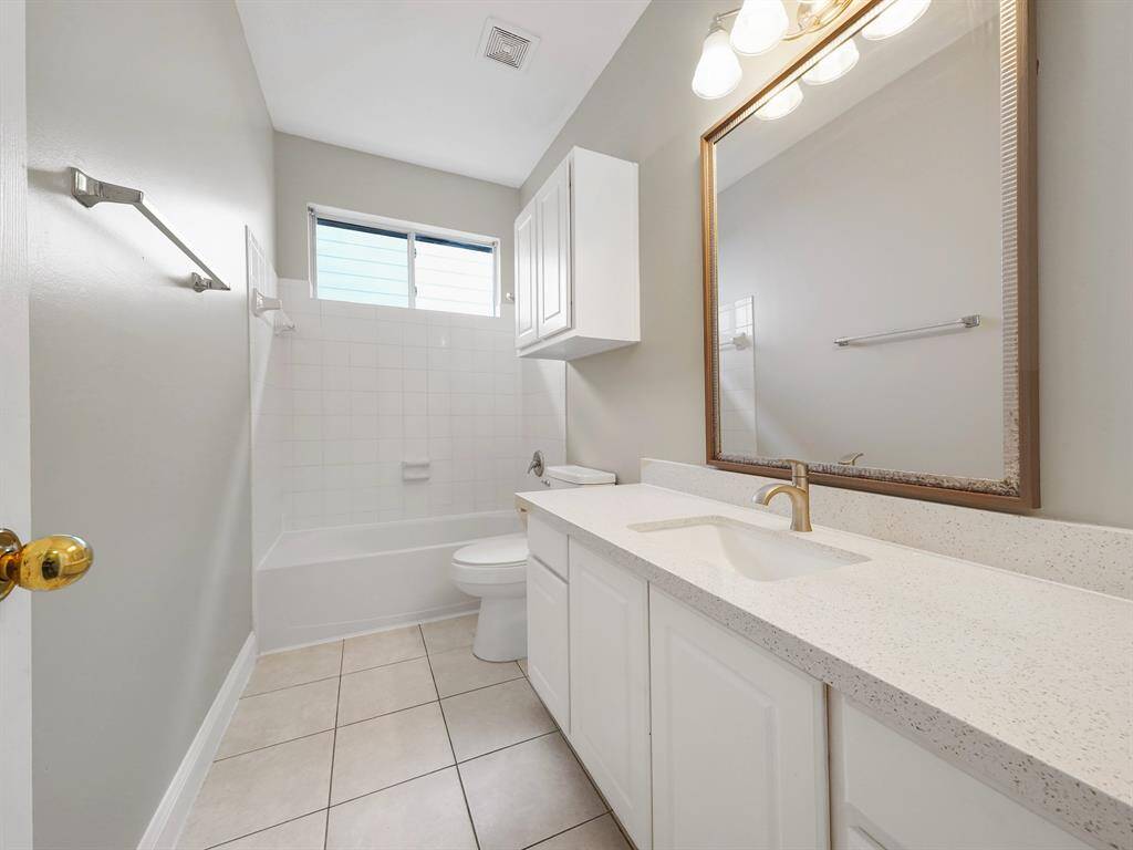 Secondary bathroom offers an extended vanity with tons of storage!