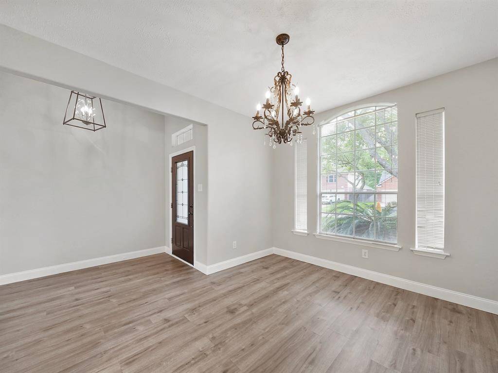 Step inside to discover a thoughtfully upgraded interior featuring elegant flooring throughout the main living areas and bedrooms, complemented by soft, soothing tones that create a sense of tranquility. The formal dining room, conveniently located off the entrance, sets the stage for memorable gatherings.