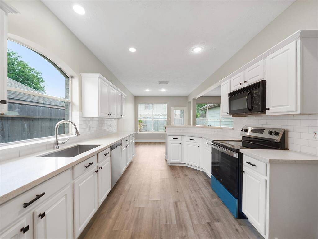 Kitchen offers tons of cabinet and counter space for storage and prep!