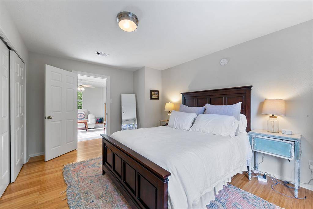 The first of three bedrooms up, the most spacious is located just off the game room and offers privacy from the rest of the upstairs occupants.  Overlooking the backyard and green space beyond, it offers two spacious closets along with beautiful bamboo flooring, combining comfort and style.