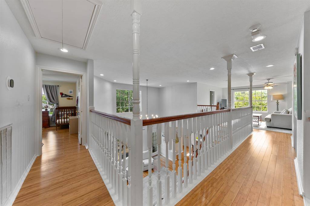 As you head downstairs, take note of the natural light that fills the upstairs gathering space and hallways, offering an open view overlooking the great room at the heart of the home.