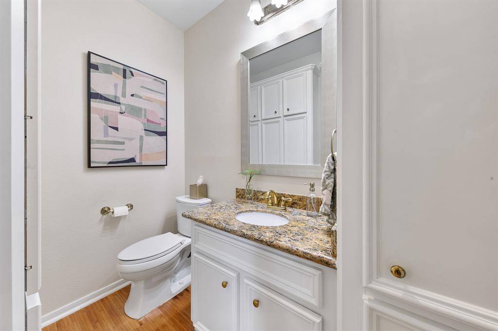 Back downstairs on our way outside, the powder room sits conveniently located between the breakfast room and the utility area.  While a more formal entry to the backyard can be found off the great room, this informal entry area leading connecting the garage and covered walkway to the kitchen area is perfect for everyday family use, especially when outdoor play involves getting dirty.