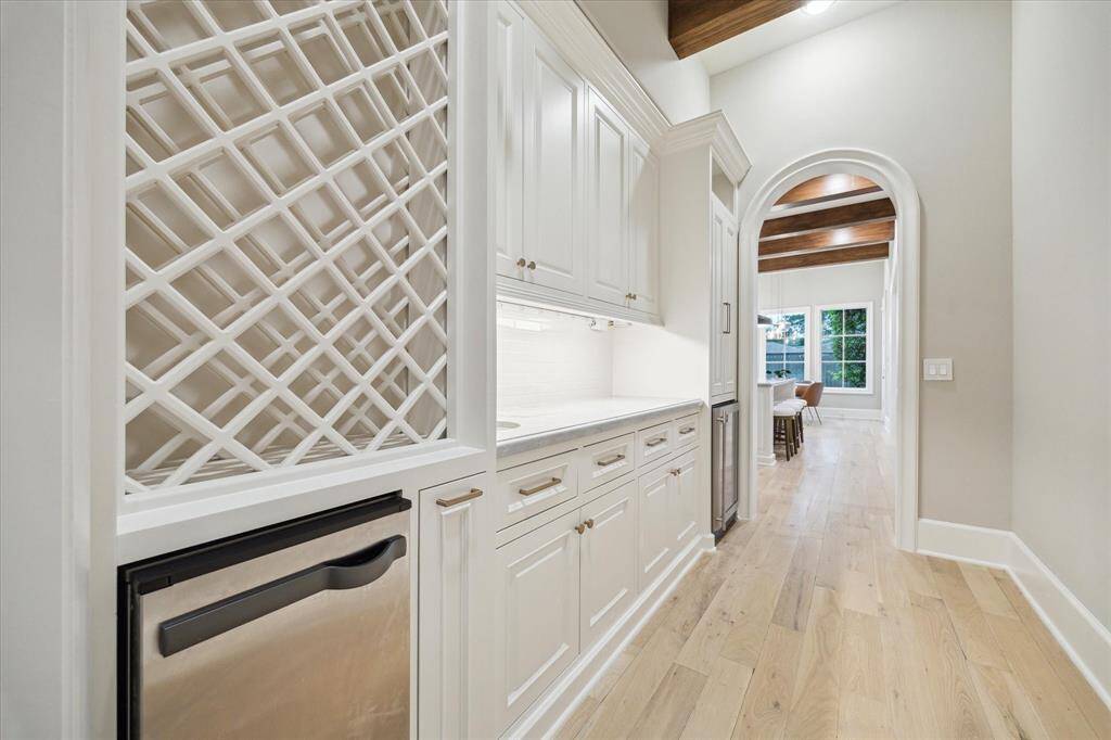 Extensive butler's pantry, ideal for hosting and entertaining features wine storage, separate ice make and wine fridge, conveniently centered between dining and kitchen.