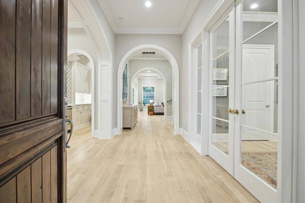As you step inside, you're greeted by a wide entryway featuring wood flooring and wide cased openings that lead seamlessly into the expansive family room.