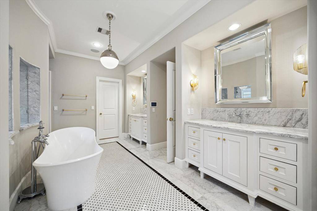 Another view of vanities and tub. Decorative basket weave pattern accent tile.