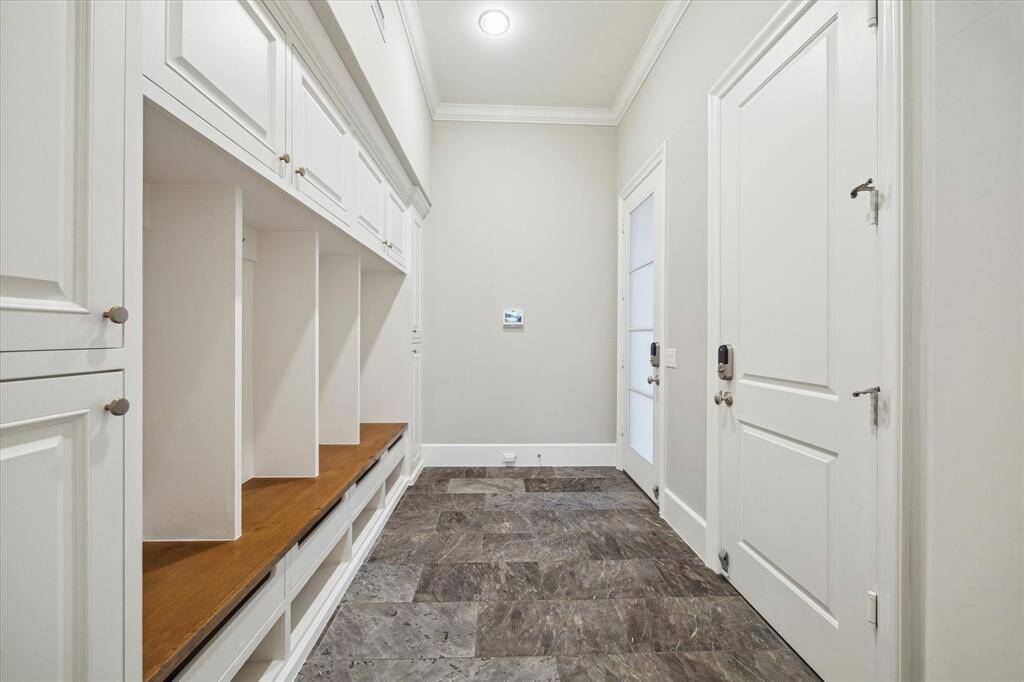 Wonderful mudroom with access from three car garage and driveway makes it convenient to unload groceries and the perfect catch-all space.