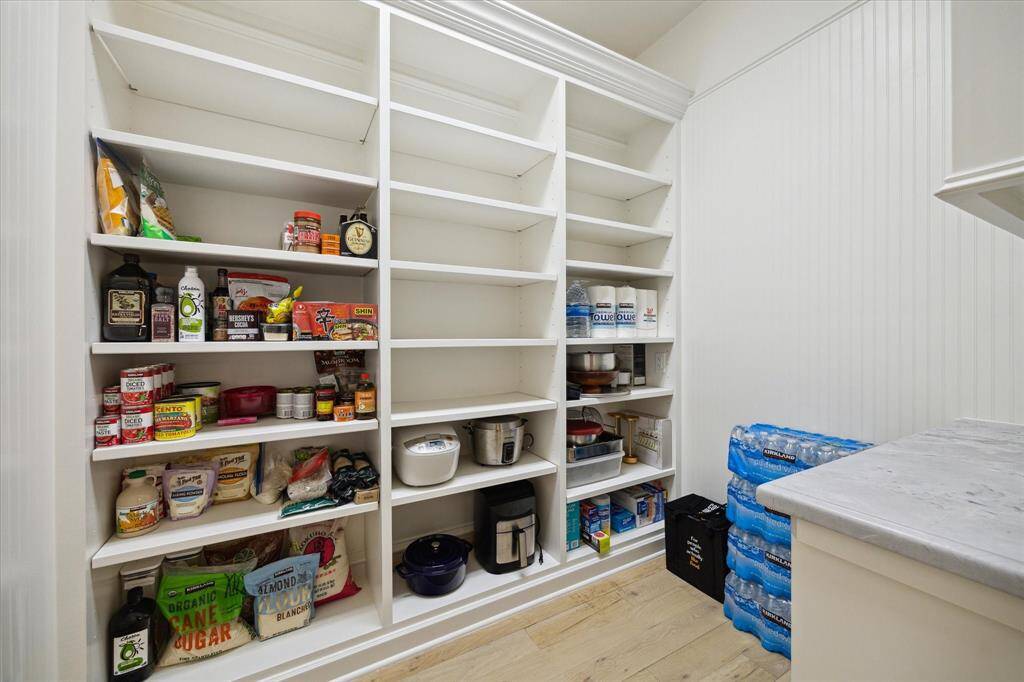 Hidden behind the kitchen cabinets, large walk-in pantry.