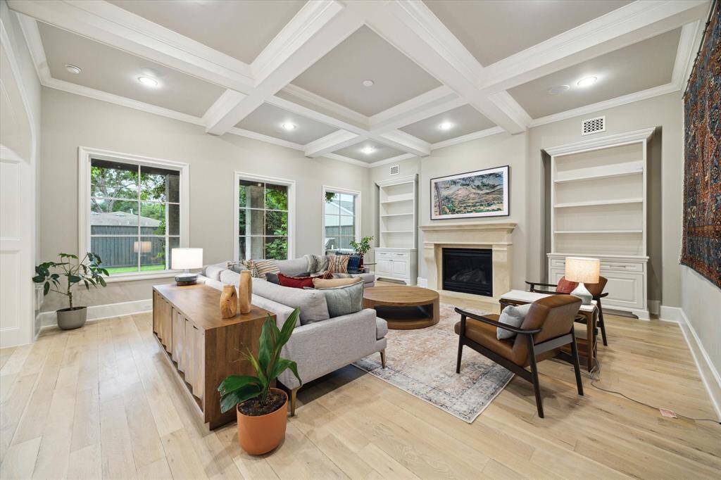Spacious family room that effortlessly opens to the kitchen, creating a harmonious flow for gatherings and entertaining. This inviting space features stunning views of the backyard, allowing natural light to pour in and enhance the ambiance. The custom cross beam ceiling adds architectural interest, while the built-in cabinetry provides both style and functionality.
