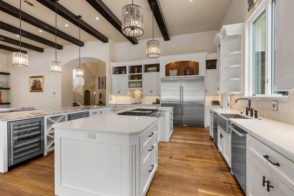 Soft close cabinets and drawers; oversized refrigerator, double ovens, gas cooktop and two dishwashers are additional highlights.