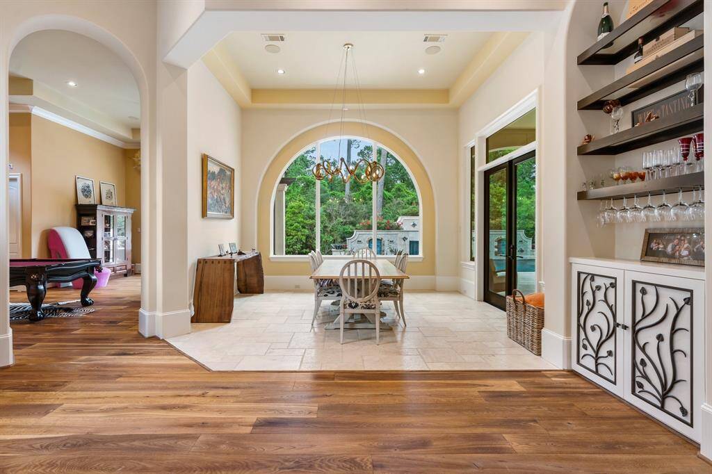 The breakfast/dining area is wrapped in views of the lush outdoor landscape.