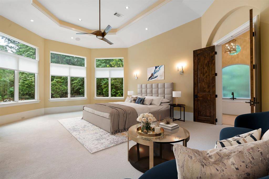 (VS) Here, the primary suite takes in views of the back yard, windows have remote screens.