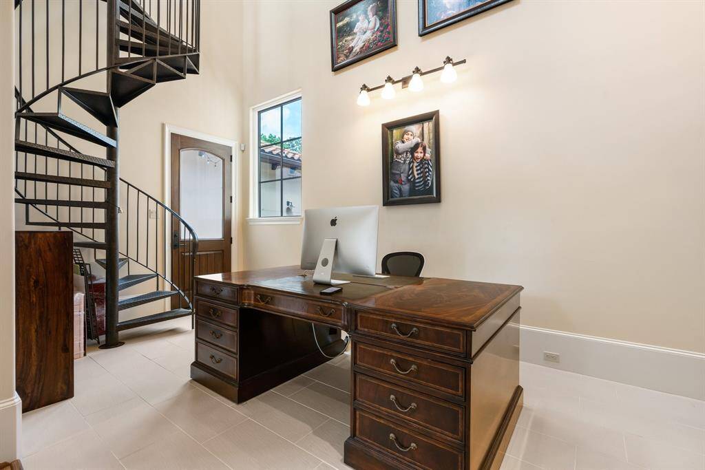 A spiral staircase adds a touch of whimsy to a two story office.