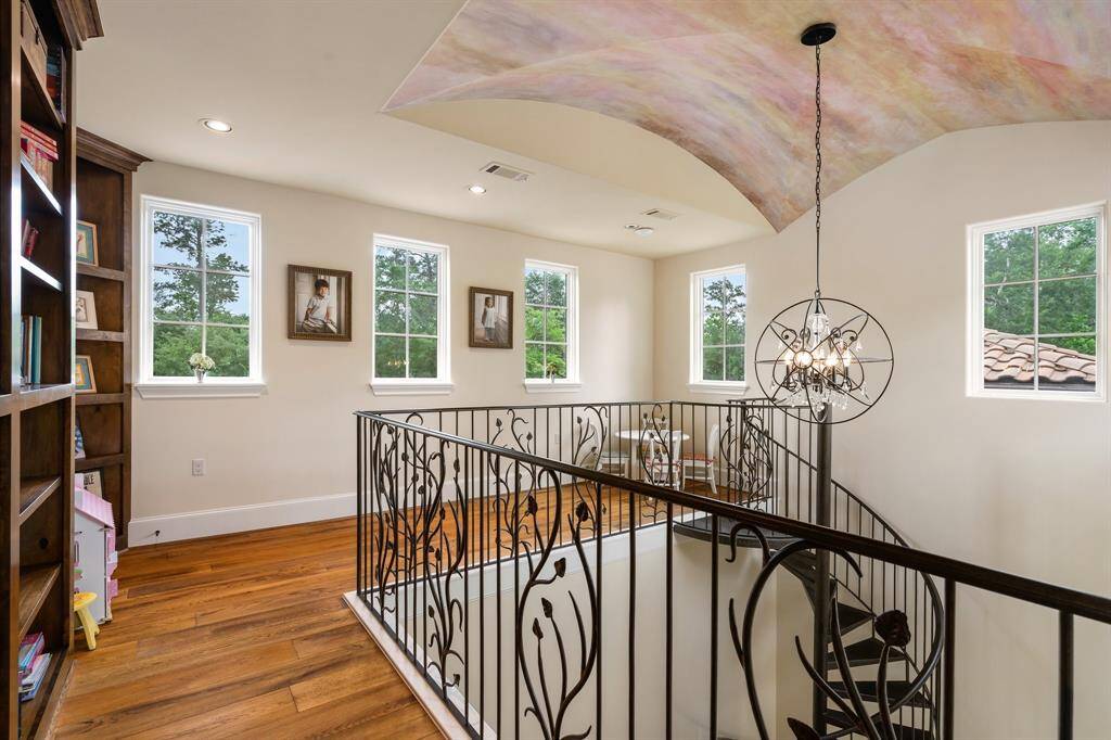 Upstairs, this light-filled space above the study offers a quiet retreat, complete with custom built-in storage and  cozy window seating nook—perfect for reading and enjoying private time.