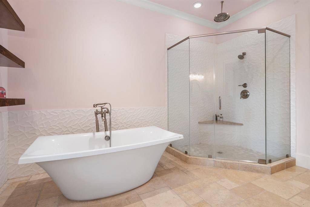 Eye catching stand alone tub and large walk-in showers and closets.