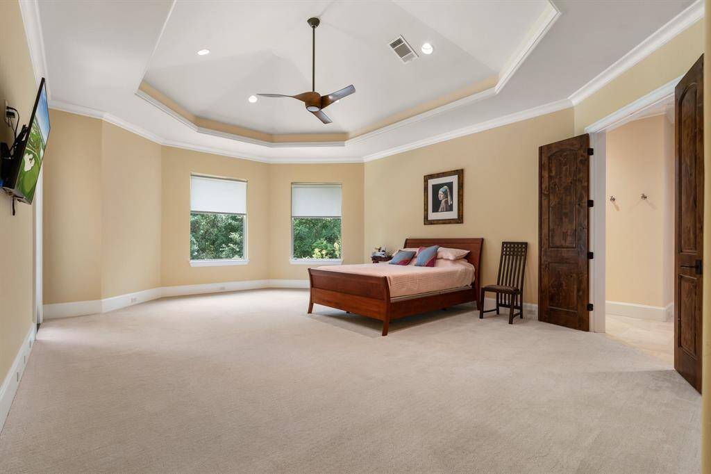 Another of the homes bedrooms is this 2nd floor suite that easily works as a second primary. There is private access to the balcony and a well though en suite bath.