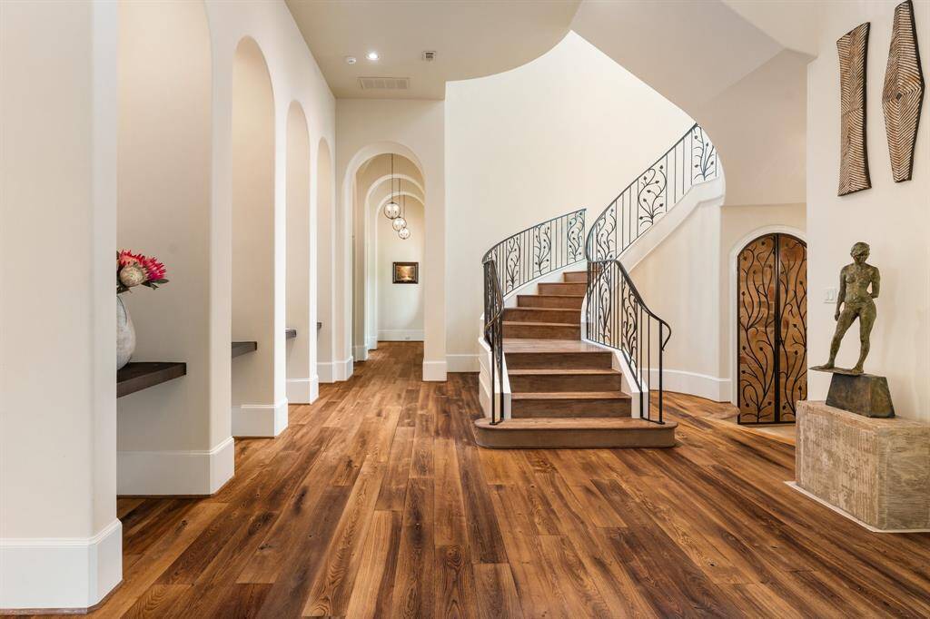 Warm wood flooring flows seamlessly throughout, complemented by soft neutral tones that enhance the home's inviting ambiance.