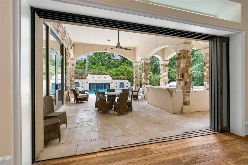 Sliding doors seamlessly retract to expand the entertaining area, effortlessly blending indoor and outdoor living.