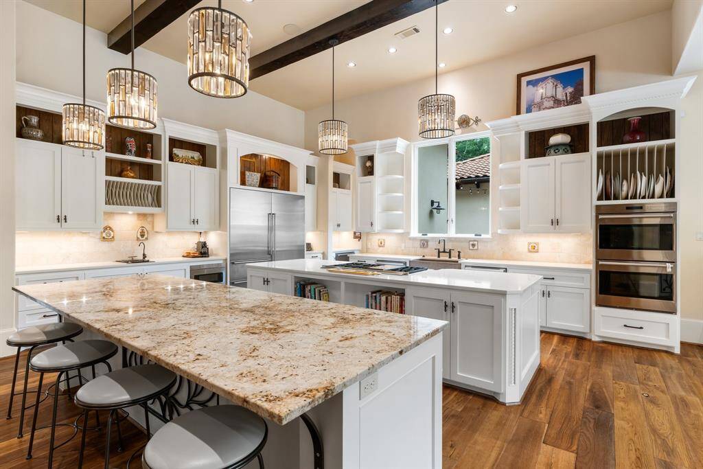 Wow factor entertaining kitchen with generous storage has two islands providing plenty of additional seating and serving space.