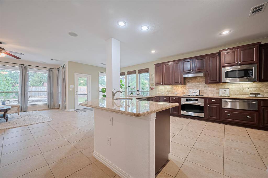 Bright open-concept kitchen & beautiful wood cabinet