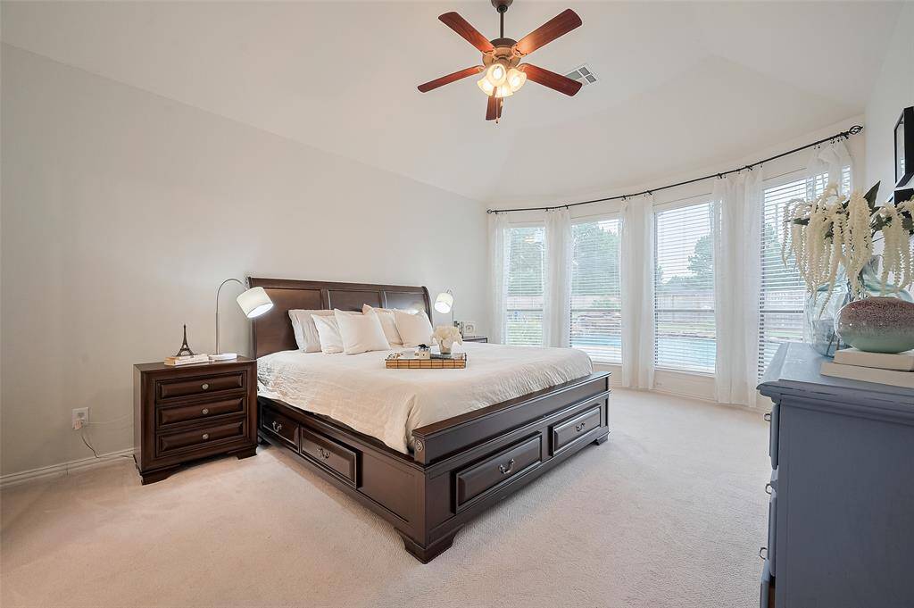 Bright & spacious bedroom W/ large window wall offering pool views.