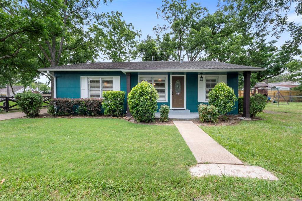 Welcome to 506 S Post Oak — a charming home nestled on a spacious lot with mature trees and a welcoming front porch.
