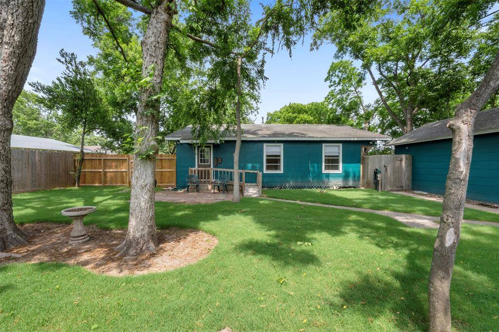 Shaded backyard with mature trees and a peaceful setting—perfect for unwinding or outdoor activities.
