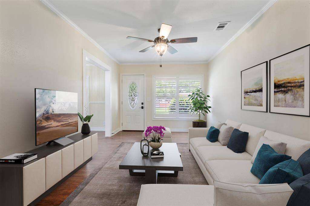 Bright and inviting living area with large windows and neutral walls, creating a cozy place to relax. (virtually staged)