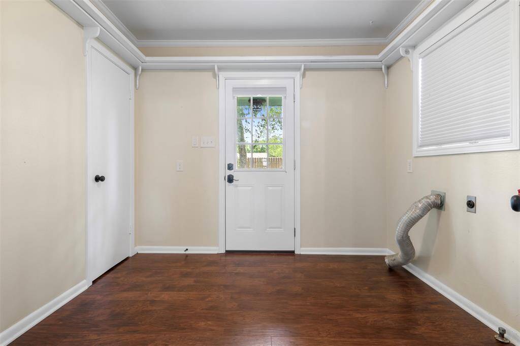 Spacious utility area with exterior access and dedicated washer/dryer connections.