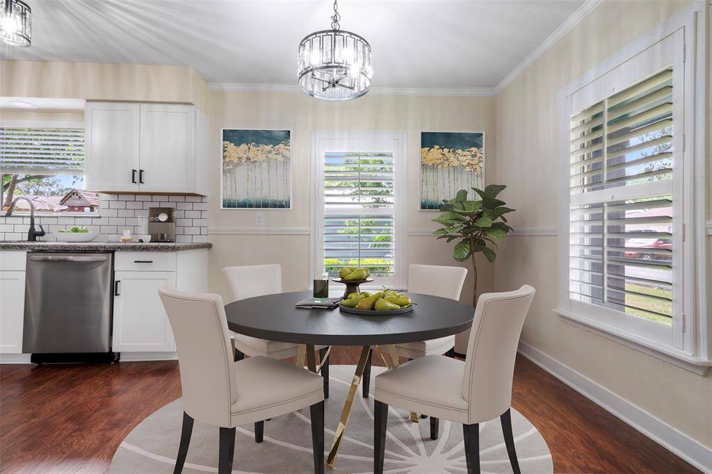 Breakfast area with large windows and cheerful natural light for relaxed morning meals.(virtually staged)