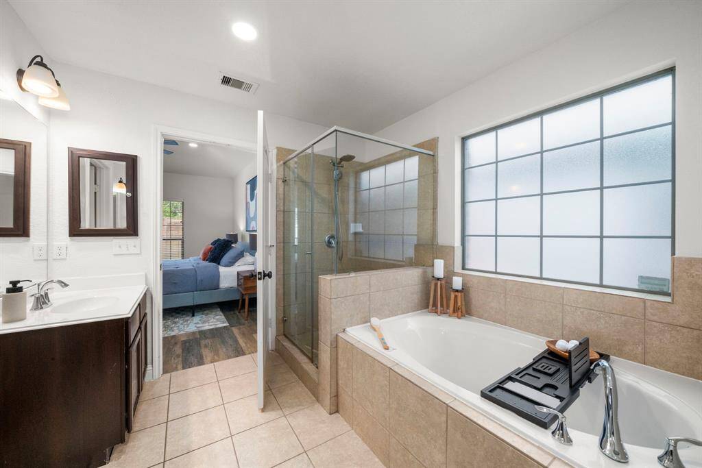Alternate view of the primary bathroom, noting the separate shower/tub.