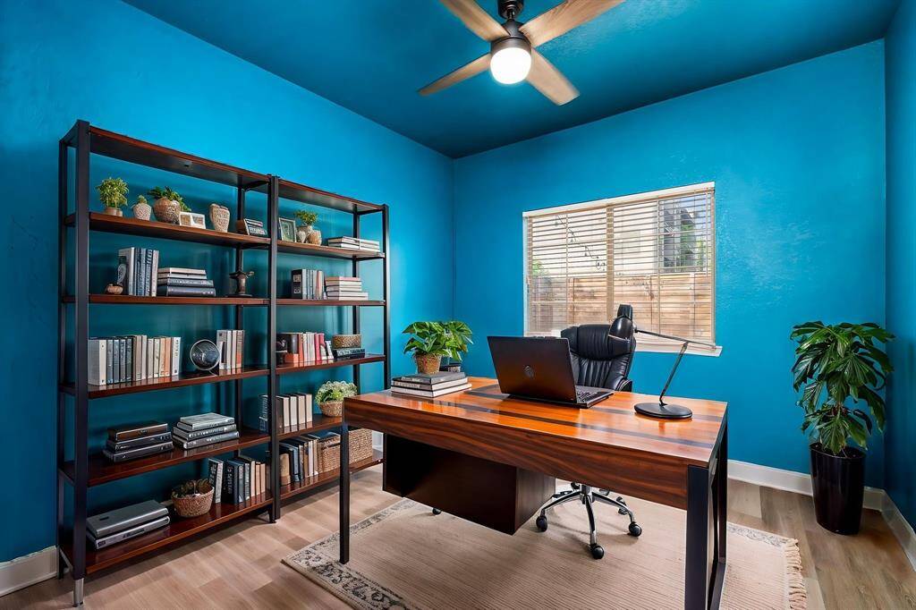 Virtually staged image of the blue room as a home office.
