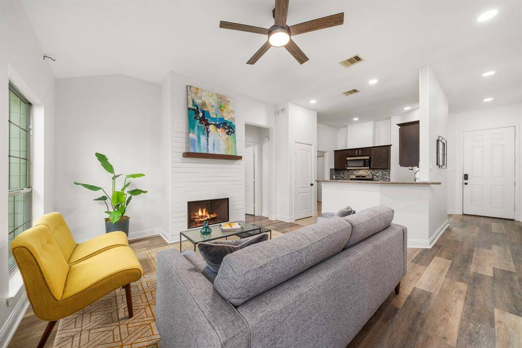 Welcome inside! The open floor plan is light and bright, and nicely anchored by a gas fireplace with custom floor to ceiling wood framed fireplace surround - subtle but crisp design features.