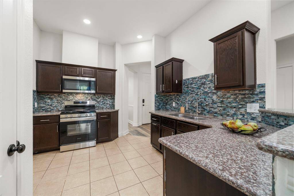Enjoy granite countertops, tile backsplash, stainless steel appliances with gas cooking.
