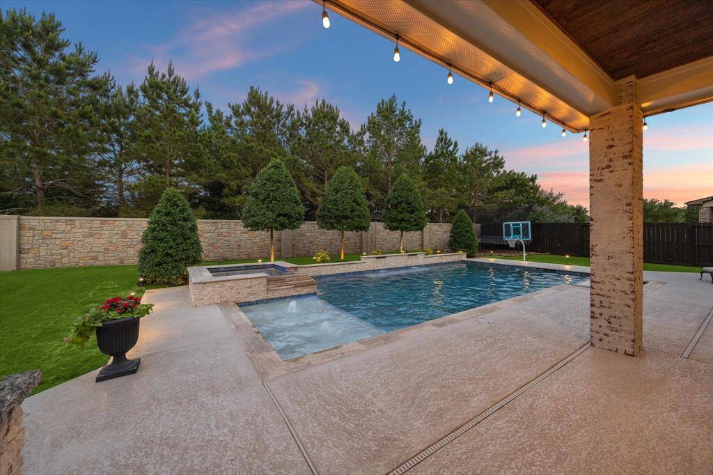 A built in basketball goal, table and seating area make this pool extraordinary!